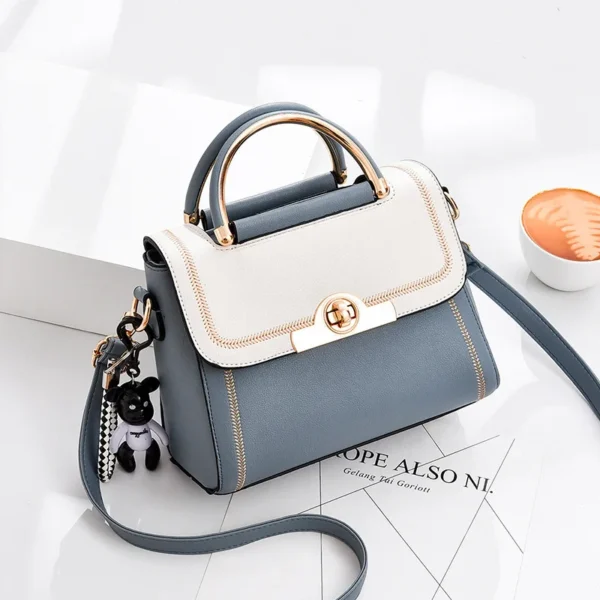 Stylish blue and white handbag with accessories.