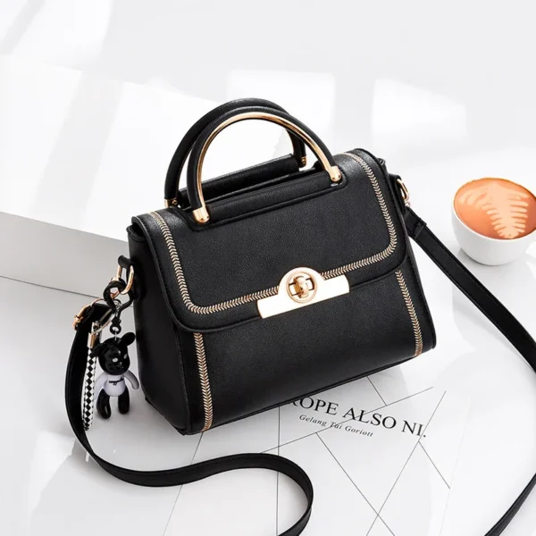 Black leather handbag with coffee on desk