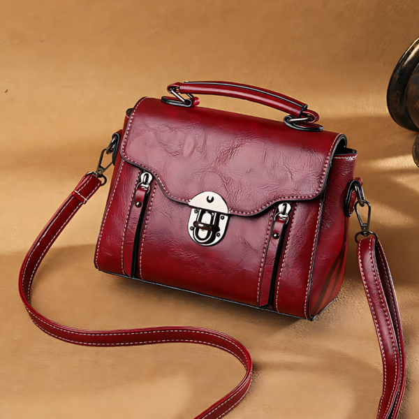 Red leather handbag with clasp and strap