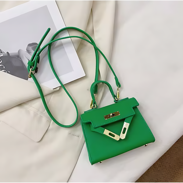 Green handbag on beige fabric and magazine