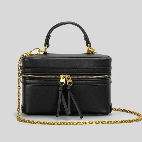 Black handbag with gold chain and zipper.