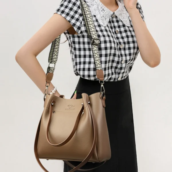 Woman with brown handbag and checkered blouse