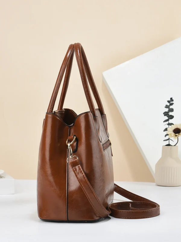 Brown leather handbag with shoulder strap.