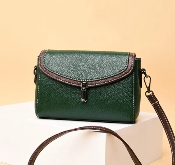 Green leather crossbody bag on display