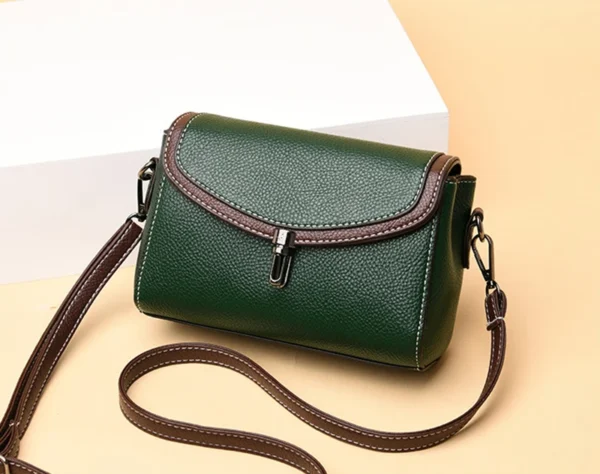 Green leather handbag with brown strap